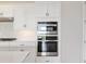 Modern stainless steel microwave/oven combination offers efficient cooking with sleek white cabinetry at 4419 Nw 54Th Ter, Ocala, FL 34482