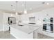 Elegant kitchen featuring all-white cabinetry, stainless steel appliances, and a spacious island for meal prep at 4419 Nw 54Th Ter, Ocala, FL 34482