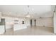 Bright, open-concept kitchen featuring white cabinets, stainless steel appliances, and a large island at 4419 Nw 54Th Ter, Ocala, FL 34482