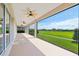 View of the spacious covered lanai, complete with ceiling fans and serene views of the landscaped backyard at 4419 Nw 54Th Ter, Ocala, FL 34482