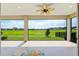 Relax on the lanai with a ceiling fan and enjoy the view of the lush green lawn and bright blue sky at 4419 Nw 54Th Ter, Ocala, FL 34482
