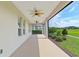 Covered lanai with ceiling fans providing comfort while enjoying the view of the green lawn and landscaping at 4419 Nw 54Th Ter, Ocala, FL 34482