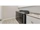 Clean laundry room with gray appliances, sink, and white cabinets at 4419 Nw 54Th Ter, Ocala, FL 34482