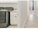 Laundry room with gray washer and dryer, sink, and white cabinets at 4419 Nw 54Th Ter, Ocala, FL 34482