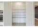 Walk-in pantry with white shelving provides ample storage space and access to the rest of the kitchen at 4419 Nw 54Th Ter, Ocala, FL 34482