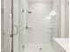 Contemporary shower featuring a glass door, shower head, and white marble-patterned tiling at 4419 Nw 54Th Ter, Ocala, FL 34482