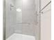 Contemporary shower with sleek tiling, glass enclosure, and grab bar for added safety and style at 4419 Nw 54Th Ter, Ocala, FL 34482