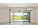 Indoor view of a large sliding glass door and outdoor patio overlooking a spacious backyard at 4419 Nw 54Th Ter, Ocala, FL 34482