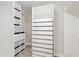 Custom walk-in closet featuring drawers, shelving, and wood-look tile flooring at 4419 Nw 54Th Ter, Ocala, FL 34482