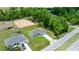 Aerial view of a home with a well-kept lawn, surrounded by trees and a neighborhood at 458 Marion Oaks Trail Trl, Ocala, FL 34473
