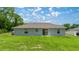 Back exterior view showcasing the home's siding and well-maintained lawn at 458 Marion Oaks Trail Trl, Ocala, FL 34473