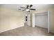 This bedroom features a closet, ceiling fan, tile floors, and natural light at 458 Marion Oaks Trail Trl, Ocala, FL 34473