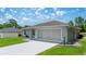 A home showcasing siding and two-car garage with a well-maintained yard at 458 Marion Oaks Trail Trl, Ocala, FL 34473
