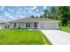 Charming single-story home with well-manicured lawn and two-car garage at 458 Marion Oaks Trail Trl, Ocala, FL 34473