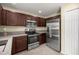 Modern kitchen featuring stainless steel appliances and dark wood cabinetry at 458 Marion Oaks Trail Trl, Ocala, FL 34473