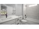 Bathroom featuring white cabinets, quarts counters, and a tub and shower at 5 Larch Course Ter, Ocala, FL 34480