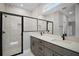 Bathroom featuring double vanity, quartz countertops, and glass shower with marble tile at 5 Larch Course Ter, Ocala, FL 34480