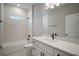 Bathroom featuring white cabinets, quarts counters, and a tub and shower with marble tile at 5 Larch Course Ter, Ocala, FL 34480