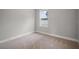 Small bedroom with a view of the exterior through the window and neutral colored carpet at 5 Larch Course Ter, Ocala, FL 34480