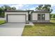 Charming single-story home featuring a two-car garage and stone accents on the facade at 5 Larch Course Ter, Ocala, FL 34480