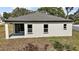 This modern home features a covered outdoor patio with sliding glass doors, and backyard windows at 5 Larch Course Ter, Ocala, FL 34480