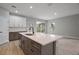 Modern kitchen with stainless steel appliances, island with sink, and gray and white cabinets at 5 Larch Course Ter, Ocala, FL 34480