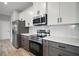 Modern kitchen with stainless steel appliances, stylish cabinets, and white countertop at 5 Larch Course Ter, Ocala, FL 34480