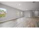 Bright open-concept living space with lots of windows and wood-look flooring at 5 Larch Course Ter, Ocala, FL 34480