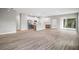 Spacious open floor plan with wood-look floors, a kitchen island, and modern appliances at 5 Larch Course Ter, Ocala, FL 34480