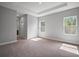 Spacious main bedroom featuring tray ceilings, natural light, and neutral carpeting at 5 Larch Course Ter, Ocala, FL 34480