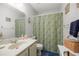 Bathroom with paisley shower curtain and vanity sink at 505 Fairways Ln # B, Ocala, FL 34472