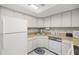 Compact kitchen with ample counter space and neutral-toned tile flooring at 505 Fairways Ln # B, Ocala, FL 34472