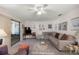 Spacious living room with a large sectional couch, area rug, and sliding glass door at 505 Fairways Ln # B, Ocala, FL 34472