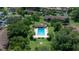 Aerial shot of a community pool surrounded by mature trees and landscaping at 505 Fairways Ln # B, Ocala, FL 34472
