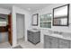 This full bathroom boasts dual sinks, granite countertops, tiled floors, and bright white walls at 510 Se 19Th St, Ocala, FL 34471