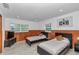 This second bedroom is complete with two beds, wood floors, and neutral decor at 510 Se 19Th St, Ocala, FL 34471