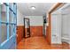 Bright foyer featuring hardwood floors, paneled walls, and an open layout that leads to the rest of the home at 510 Se 19Th St, Ocala, FL 34471