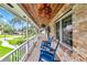 Relaxing covered front porch featuring rocking chairs and a beautiful wood ceiling, creating a cozy outdoor space at 510 Se 19Th St, Ocala, FL 34471