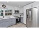 Contemporary kitchen with stainless steel appliances, sleek countertops, and stylish white and gray cabinetry at 510 Se 19Th St, Ocala, FL 34471
