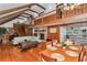 Spacious living room with wood beams, fireplace, and open floor plan to the kitchen at 510 Se 19Th St, Ocala, FL 34471