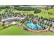 Stunning aerial view of the community clubhouse, pool, and golf course with lush landscaping and mature trees at 5233 Nw 43Rd Lane Rd, Ocala, FL 34482