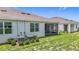 Attractive home with a screened-in patio, lush green yard, and efficient outdoor cooling units at 5233 Nw 43Rd Lane Rd, Ocala, FL 34482