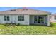 Well-maintained home showcasing a screened lanai, manicured lawn, and modern AC units at 5233 Nw 43Rd Lane Rd, Ocala, FL 34482