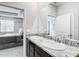 Bathroom with double granite vanity and mirrors and neutral walls at 5233 Nw 43Rd Lane Rd, Ocala, FL 34482