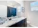 Well-lit bathroom featuring granite vanity with dark wood cabinetry and a framed mirror at 5233 Nw 43Rd Lane Rd, Ocala, FL 34482