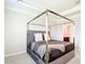 Bedroom featuring a canopy bed with velvet headboard and neutral walls at 5233 Nw 43Rd Lane Rd, Ocala, FL 34482