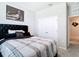 Bright bedroom featuring a bed, closet, and view into the hallway at 5233 Nw 43Rd Lane Rd, Ocala, FL 34482