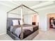 Bright bedroom featuring a canopy bed with velvet headboard, walk-in closet, and ensuite bathroom at 5233 Nw 43Rd Lane Rd, Ocala, FL 34482