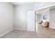 Cozy bedroom with soft carpet, neutral walls, and an open doorway leading to a spacious living area at 5233 Nw 43Rd Lane Rd, Ocala, FL 34482