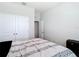Neutral bedroom featuring a bed, closet, and suitcase at 5233 Nw 43Rd Lane Rd, Ocala, FL 34482